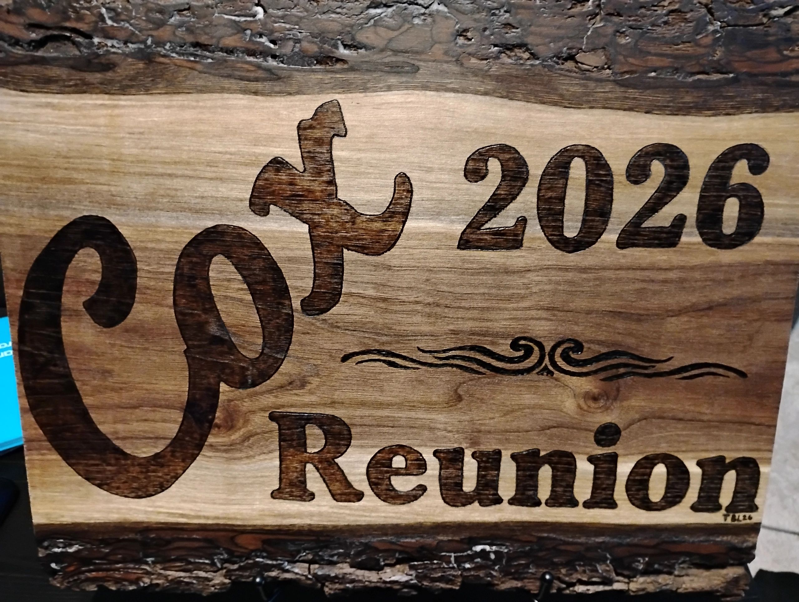 Personalized Cox 2026 reunion sign on bark-edged wood
